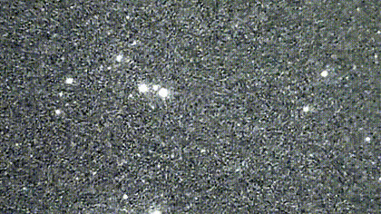 Satellite moving through a grainy night-sky field above Orion.